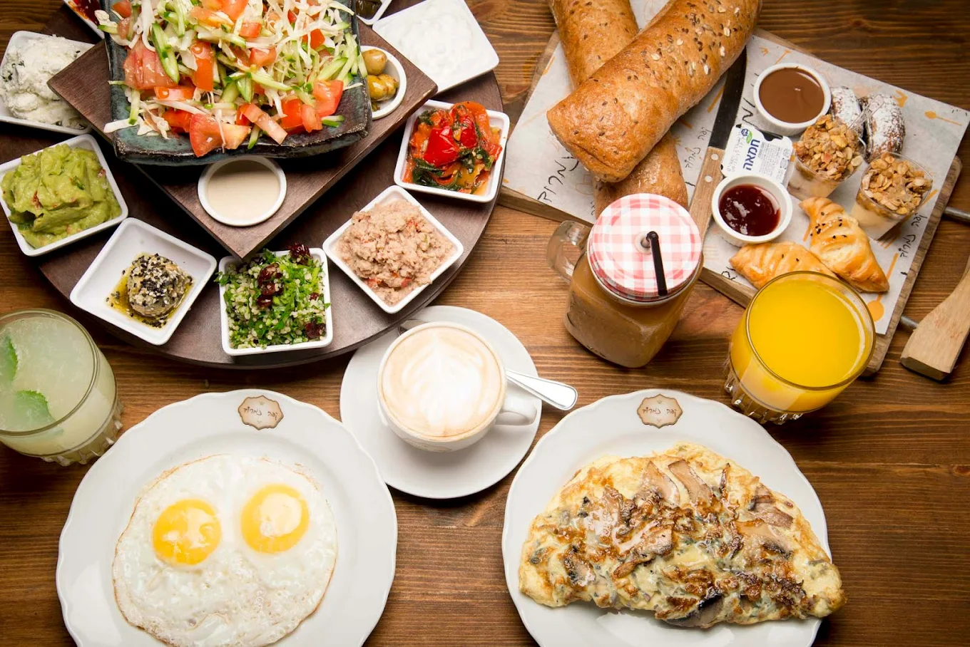 Café Nimrod Israeli breakfast spread with eggs, salads, bread and fresh juice